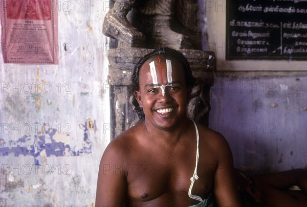 Vaishnavite Priest sitting with smile