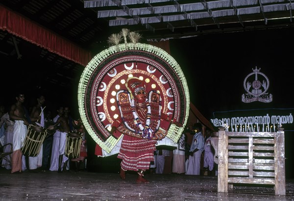 Theyyam or Teyyam ritual dance performing in Kerala Kalamandalam at Cheruthuruthy