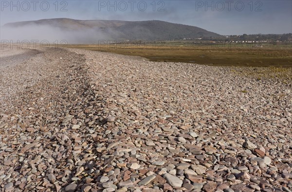 View of shingle bank spreading inland as sea levels rise