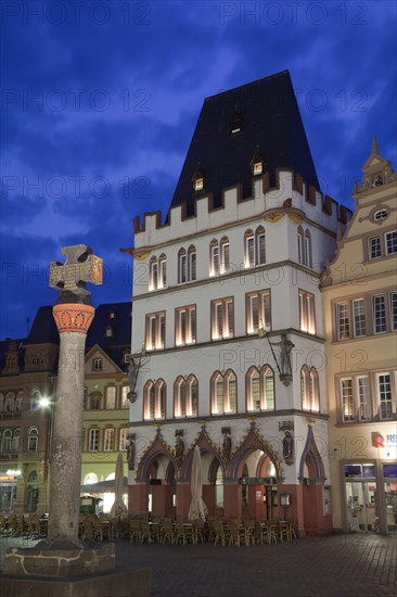 Market cross and restaurant illuminated at night