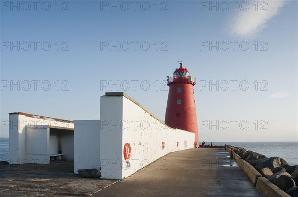 Lighthouse on the sea wall protecting the harbour entrance