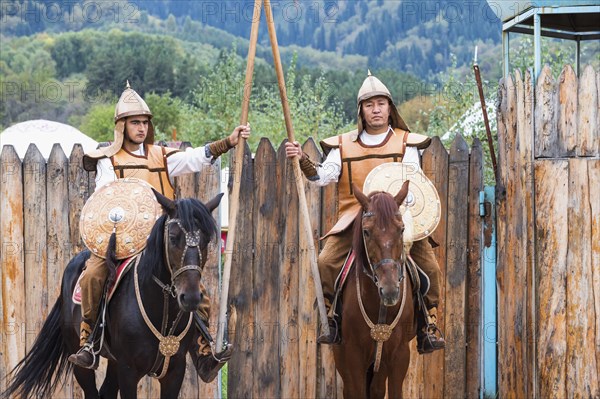 Two horsemen in front of the entrance to the Kazakh ethnographic village of Aul Gunny