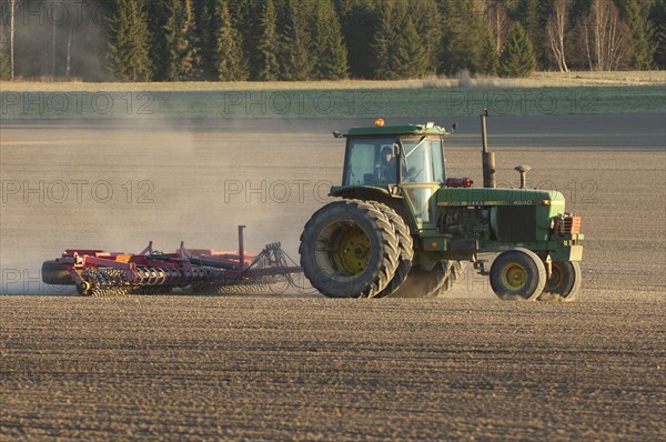 John Deere 4240 tractor with harrows