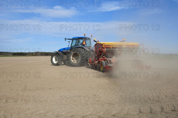 New Holland TM150 tractor with Vaderstad seed drill
