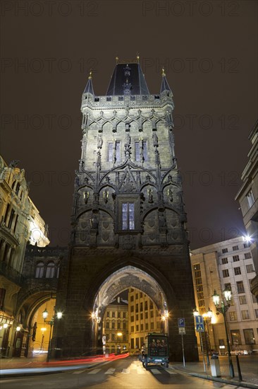 Gothic city gate tower illuminated at night