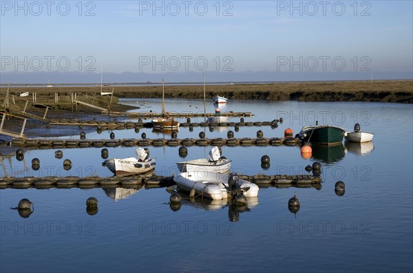 View of boats moored in the coastal creek