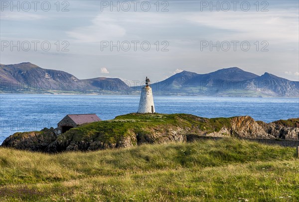 View of lighthouse and coastline on tidal island