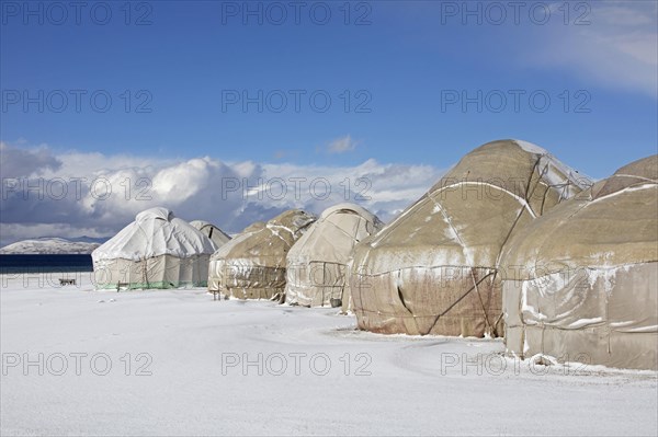 Yurts in a traditional Kyrgyz yurt camp in the snow at Song-Kul Lake