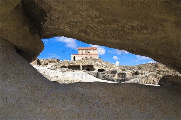 Christian princely basilica from the 10th century with view through a rock arch