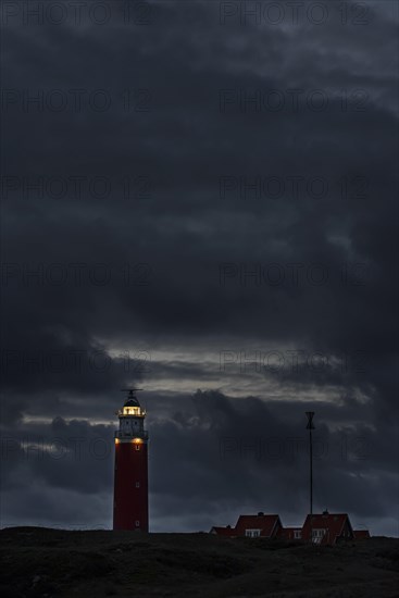 Eierland lighthouse with lantern light over the Wadden Sea at night on the Dutch island of Texel
