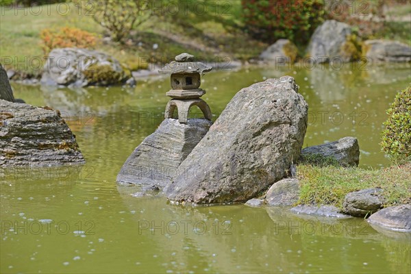 Typical Japanese garden with stone decorations