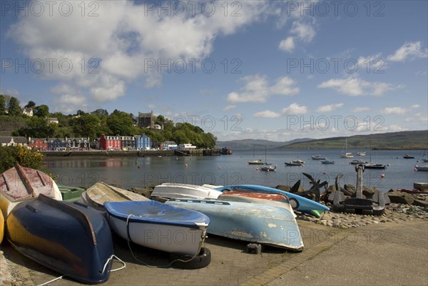 View of boats and anchors on waterfront of coastal town