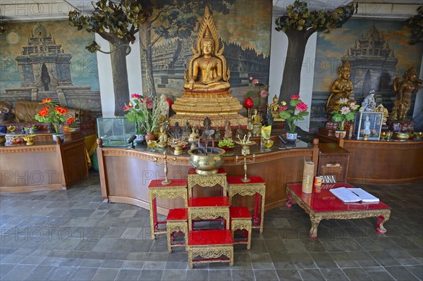 Buddha statue on an altar in a prayer room of the Buddhist monastery Brahma Vihara