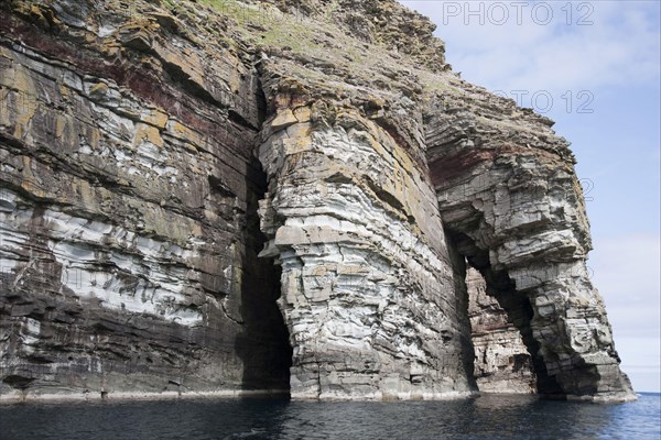 Sea cliffs and arched rocks