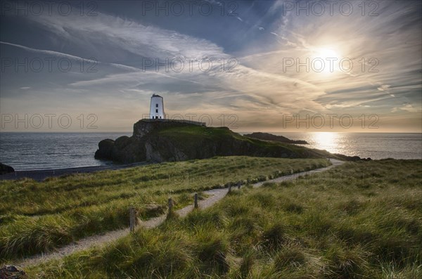 View of lighthouse and coastline on tidal island