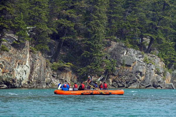 Tourists in a rubber dinghy rafting on the Bow River near Banff