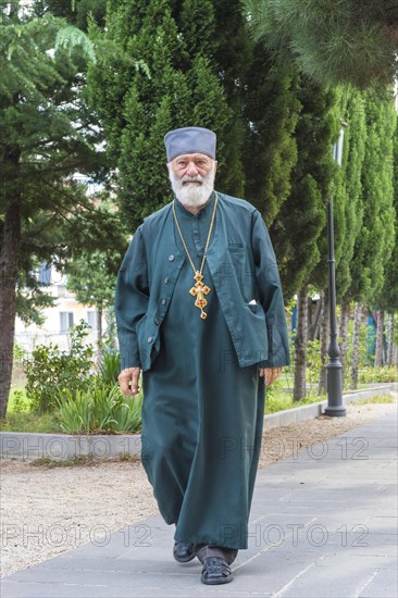 Orthodox Pope walking in a park