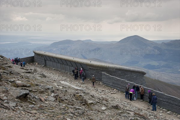 Hafod Eryri Visitor Centre and walkers on the mountain top