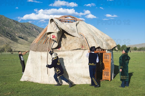 Kazakh men building a yurt