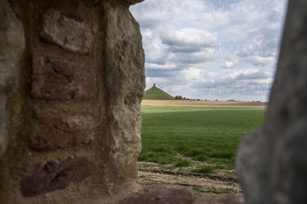 View over the Waterloo battlefield and Lion's Hill through a loophole in the garden wall of the Chateau d'Hougoumont