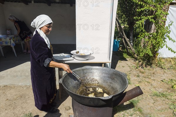 Kazakh woman preparing traditional local tandyr bread