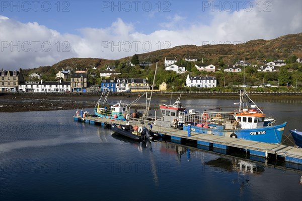 View of boats moored at the jetty in the loch