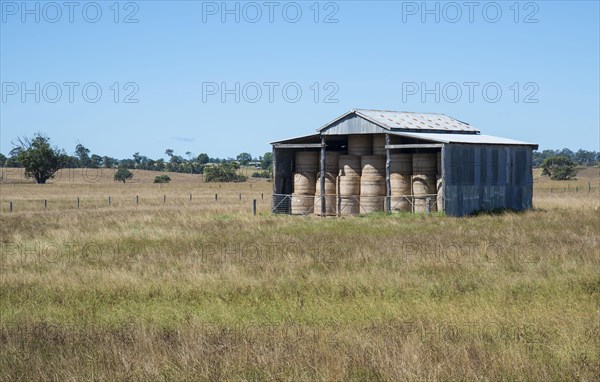 Farm building with round hay bales