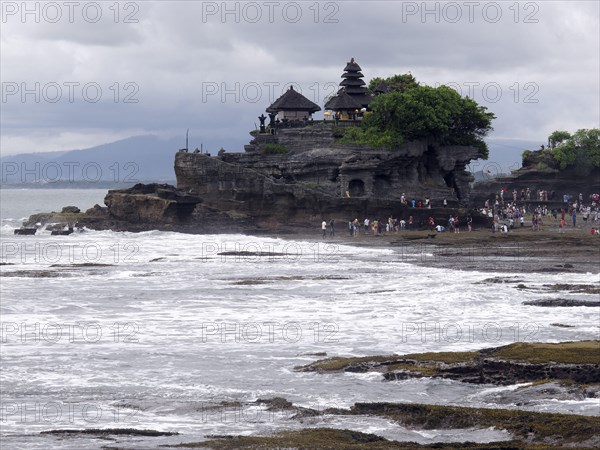 View from tourists in the temple on a rock formation on the coast