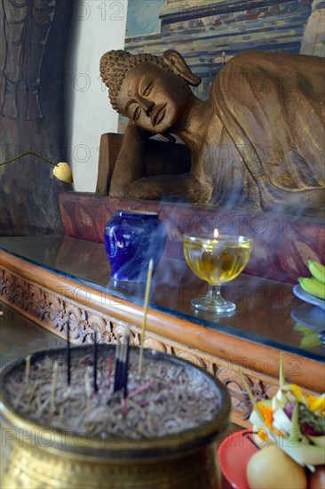 Reclining Buddha statue on an altar in a prayer room of the Brahma Vihara Buddhist monastery