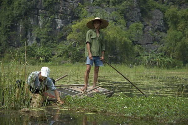 Men fishing from a boat on the waterway