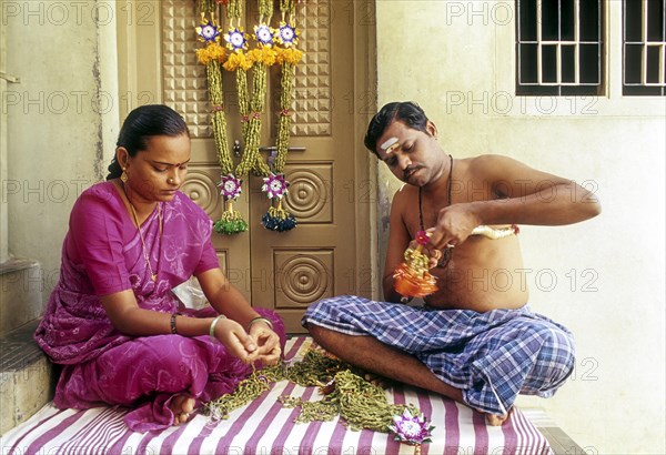 Garland of cardamom being made in Bodinayakkanur