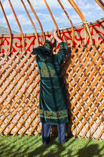 Kazakh men building a yurt