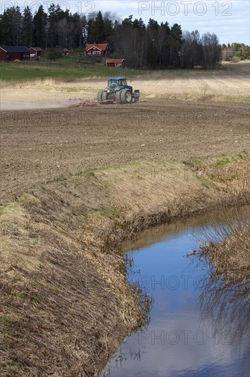 New Holland 8770 tractor with harrows