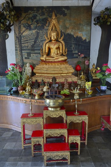 Buddha statue on an altar in a prayer room of the Buddhist monastery Brahma Vihara