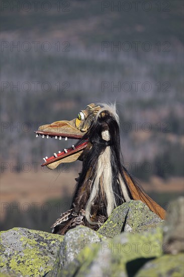 Creepy wooden devil figure on the summit of the Lusen in autumn