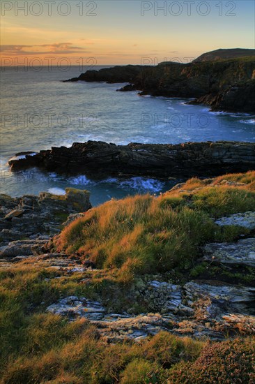 View of coastline and cliffs at sunset