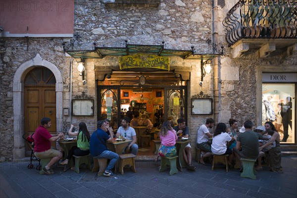 People sitting in front of restaurant