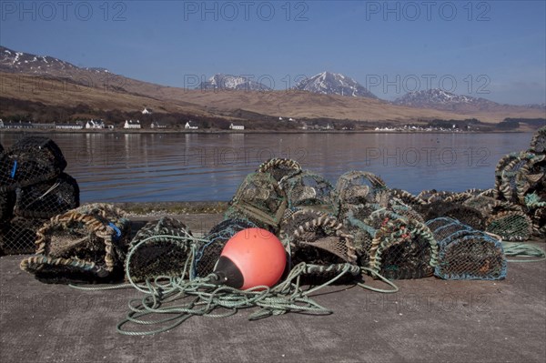 Lobster pots and floats on the pier at Craighouse with the porridge from the Jurassic behind them