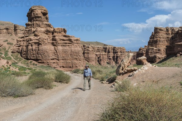 Man walking on the road in Sharyn Canyon National Park and Valley of Castles