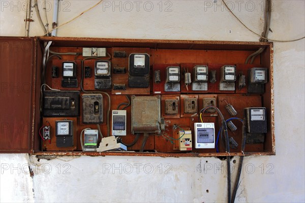 Several electricity meters on one wall