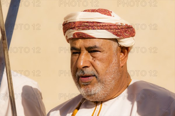 Man performing traditional songs during the Friday Goat Market in Nizwa