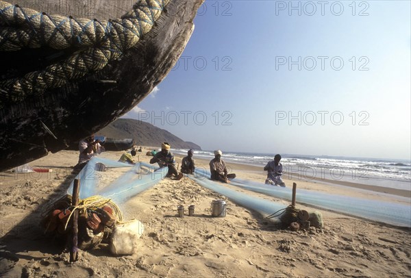 Fishermen repairing their fishing nets in Gangavaram