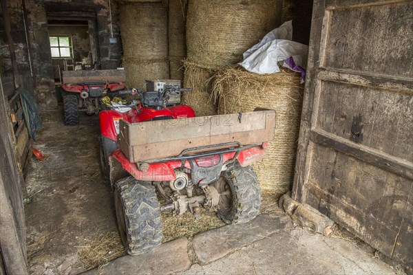 Two Quadbikes in barn on farm