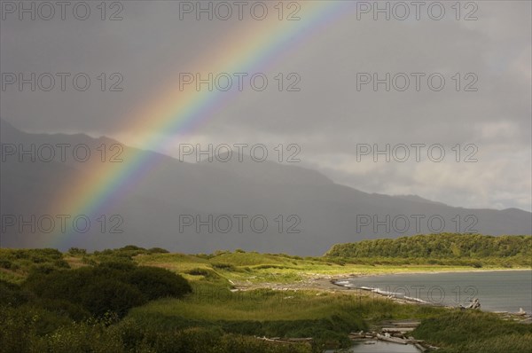 View of rainbow over coastal habitat