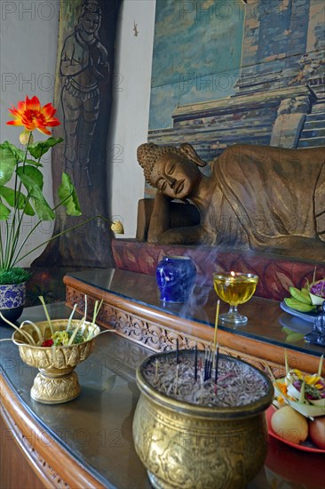 Reclining Buddha statue on an altar in a prayer room of the Brahma Vihara Buddhist monastery