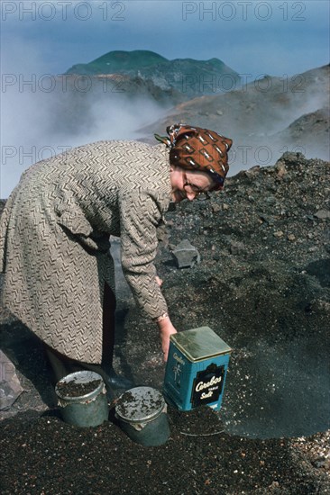 Woman baking bread in the heat of the lava flow