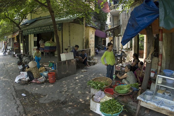 Woman selling vegetables on the street in the city