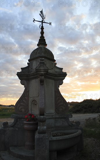 Memorial drinking fountain at sunset