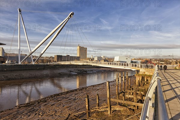 View of tidal river and footbridge