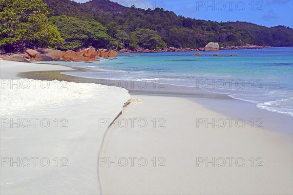 Beach and rocks of Anse Lazio in the evening